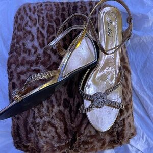 Shully’s gold wedge heels with crystal toe embellishments. W10.
